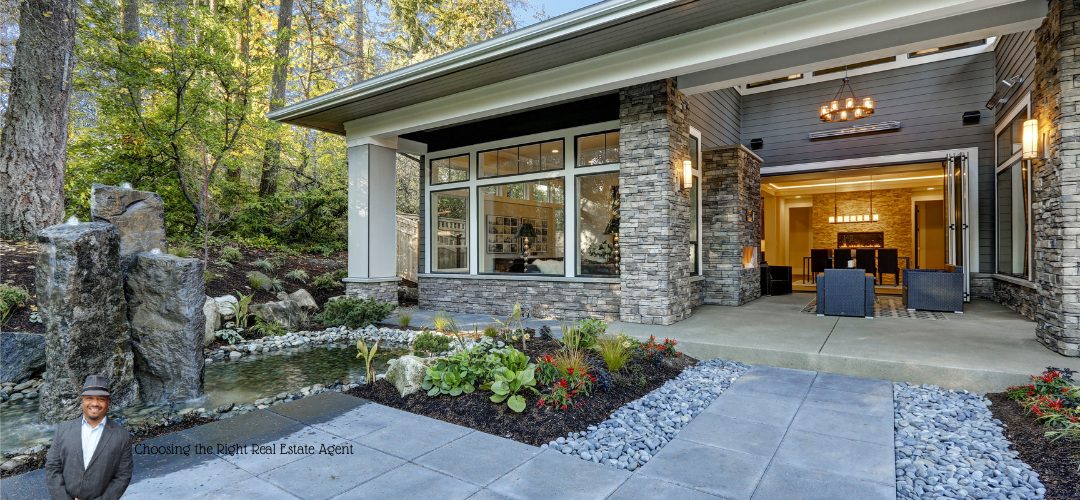 A modern house with large windows and a stone facade, surrounded by lush greenery and a small pond. A person in a suit and hat is pictured in the lower left corner with the text "Choosing the Right Real Estate Agent." The scene is serene and inviting, highlighting the home's outdoor features.