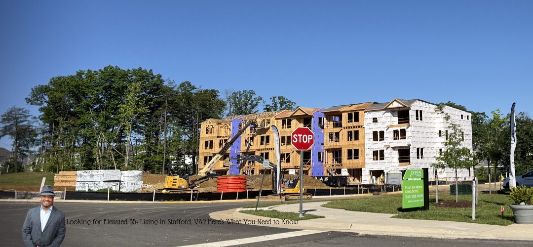 A construction site featuring a multi-story wooden-framed building under a clear blue sky, surrounded by trees. A stop sign, along with construction materials and a crane, is visible in the foreground. A person in a suit and hat stands on the left. Text reads, "Looking for Elevated 55+ Living in Stafford, Virginia? Here's What You Need to Know."