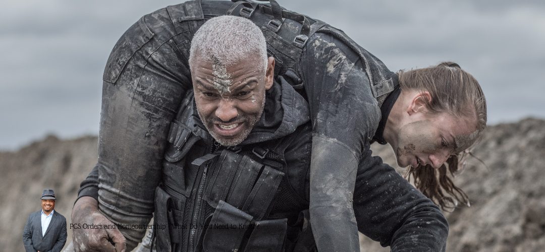 A determined man with short gray hair and a tactical vest carries a person over his shoulders during a military exercise in a muddy, rugged terrain. Both individuals are covered in mud, indicating intense physical activity. In the lower left corner, there is a small image of a man in a suit and hat with text reading, "PCS Orders and Homeownership: What Do You Need to Know?"