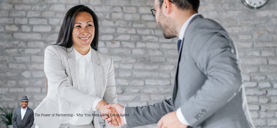 A woman and a man in business attire smiling as they shake hands in an office setting with a brick wall backdrop. A small inset image of a man in a suit and hat is in the lower left corner. Text overlay reads: "The Power of Partnership - Why You Need a Real Estate Agent."