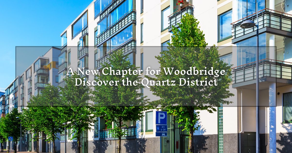 A diverse group of three people sitting at a wooden table, collaborating and discussing something on a laptop. They appear focused and engaged, with papers and a pen in hand. The background shows a modern interior with plants and large windows. There is text overlay that reads "A New Chapter for Woodbridge - Discover the Quartz District," along with a small inset image of a person in the corner.