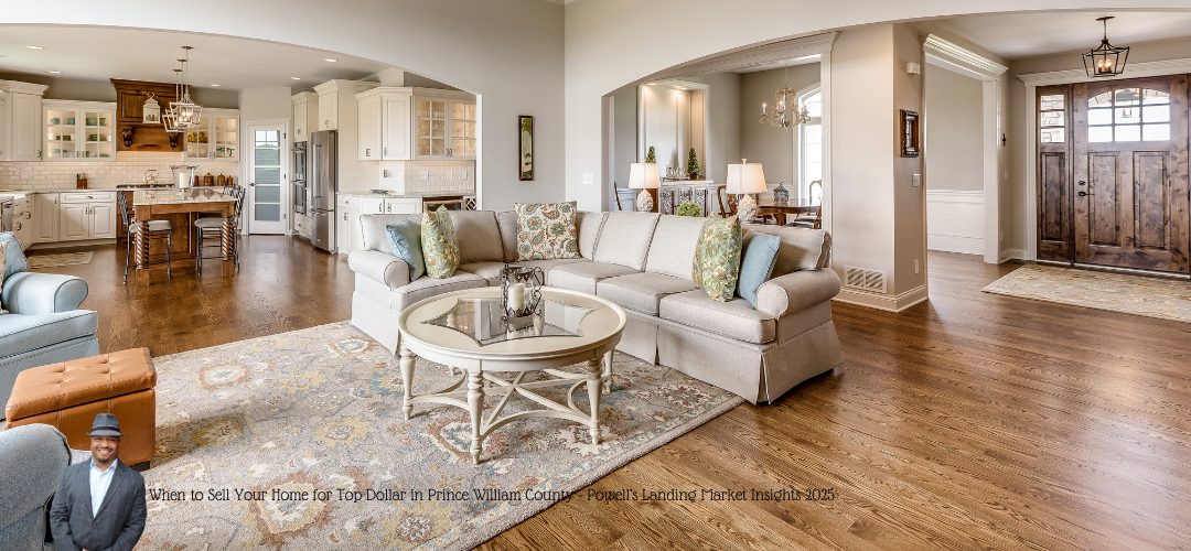 A spacious open-plan living room and kitchen with hardwood floors. The room features a large beige sectional sofa with patterned cushions, a glass-top coffee table on a decorative rug, and a kitchen area with white cabinetry and a wooden island. Elegant pendant lighting hangs above the island. A man in a suit is overlaid in the bottom left corner. Text on the image reads, "When to Sell Your Home for Top Dollar in Prince William County - Powell's Landing Market Insights 2023."